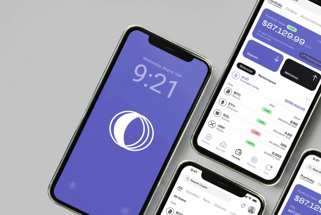 A group of mobile phones sitting next to each other with a crypto trading interface displayed on them.
